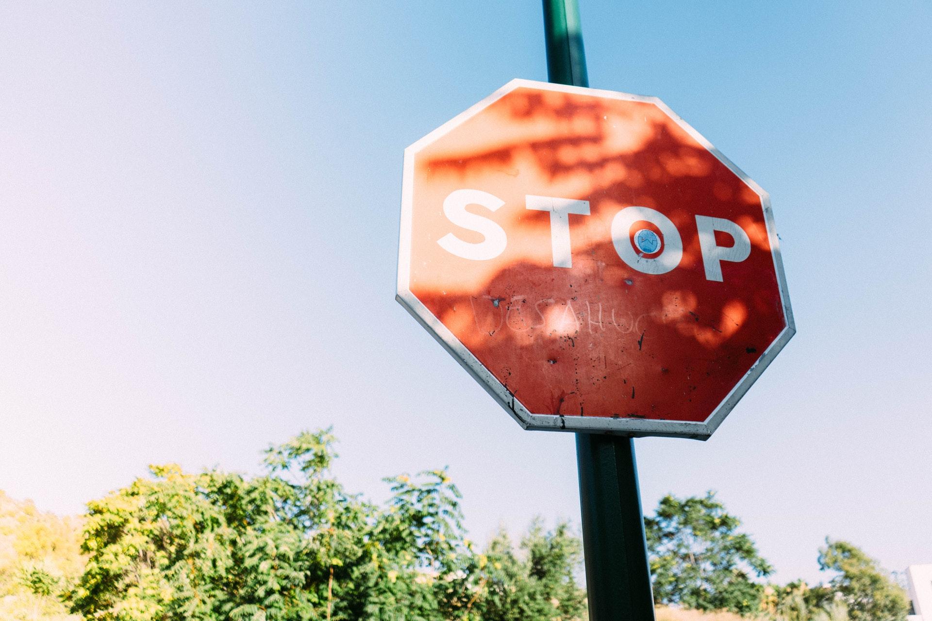 Stop Written on a traffice sign board